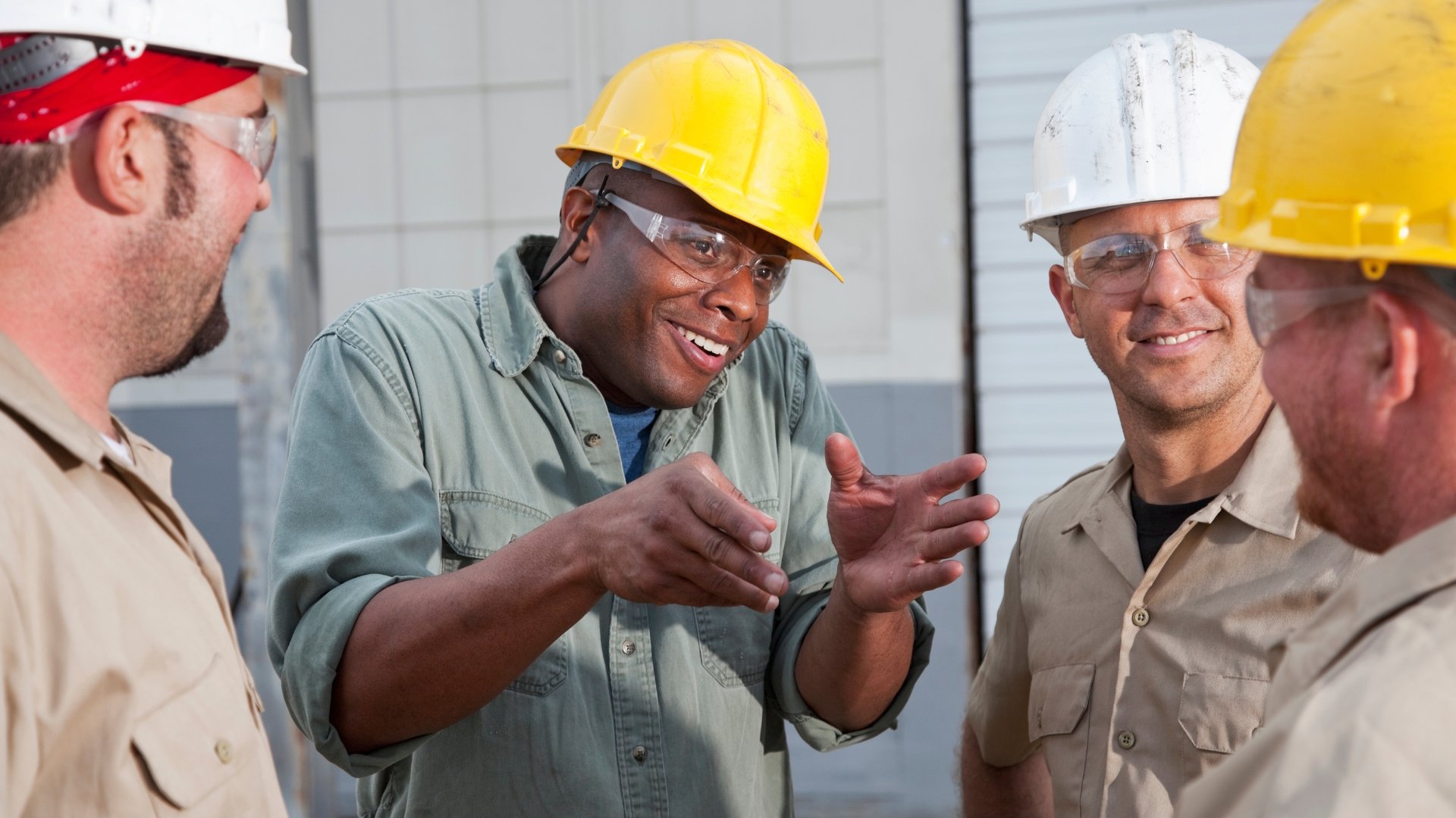 a smiling supervisor guides his team